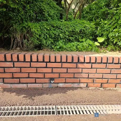 재조적을 마친 화단 담장 정면, 하단에 물구멍이 보임